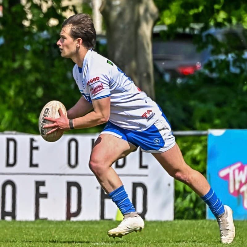 Brendan Bennett, founder of Frostlete, passing a ball during a rugby match
